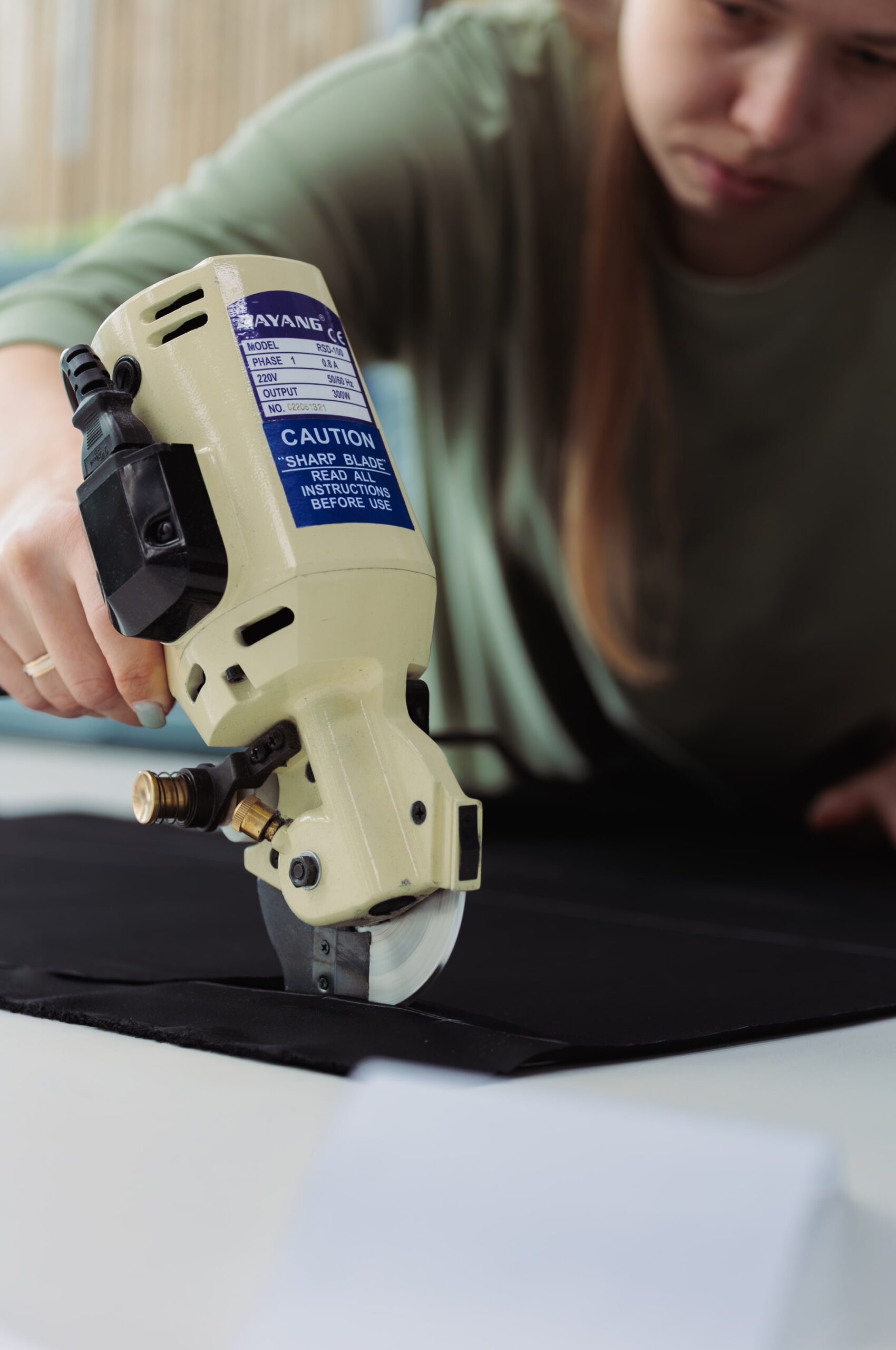 Professional fabrics cutter at merch laboratory