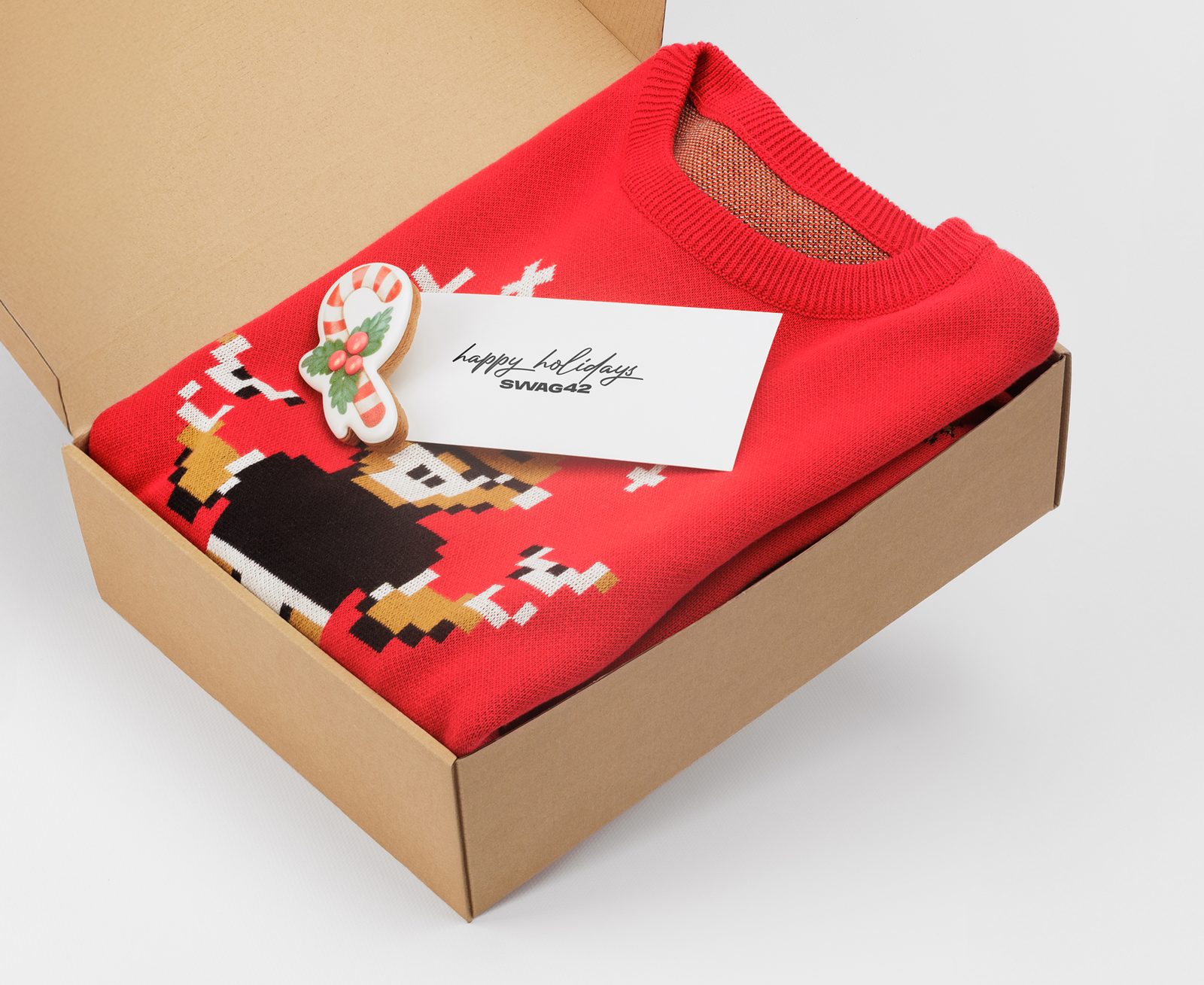 Red cotton holiday sweater packed in a kraft gift box with a Swag42 card