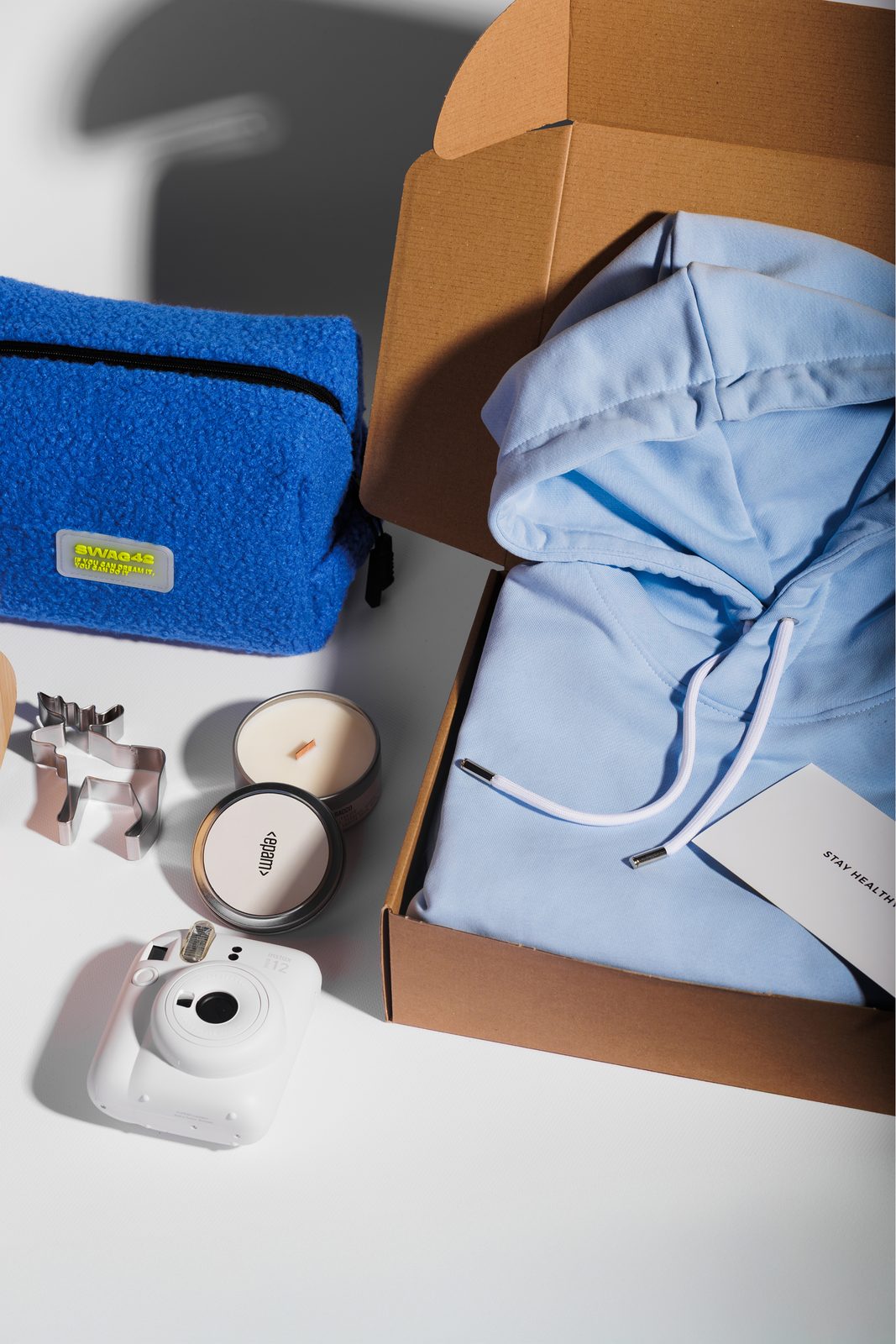 Corporate Christmas gift set with a hoodie in a kraft box, a teddy pouch, a candle and an instant camera