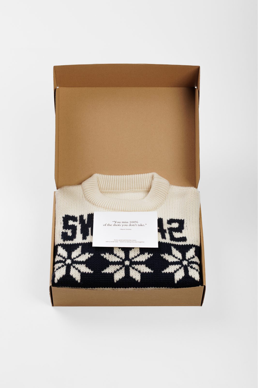 Merino wool sweater with a snowflake pattern in a kraft gift box